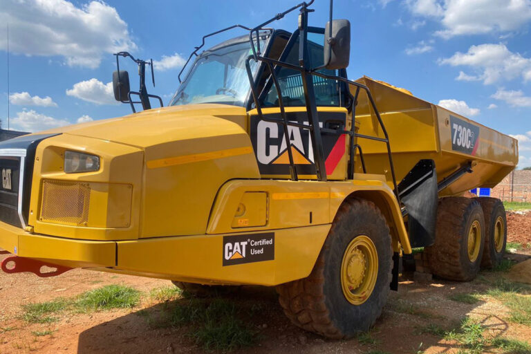 Yellow ADT (articulating dump truck) parked in a truck yard