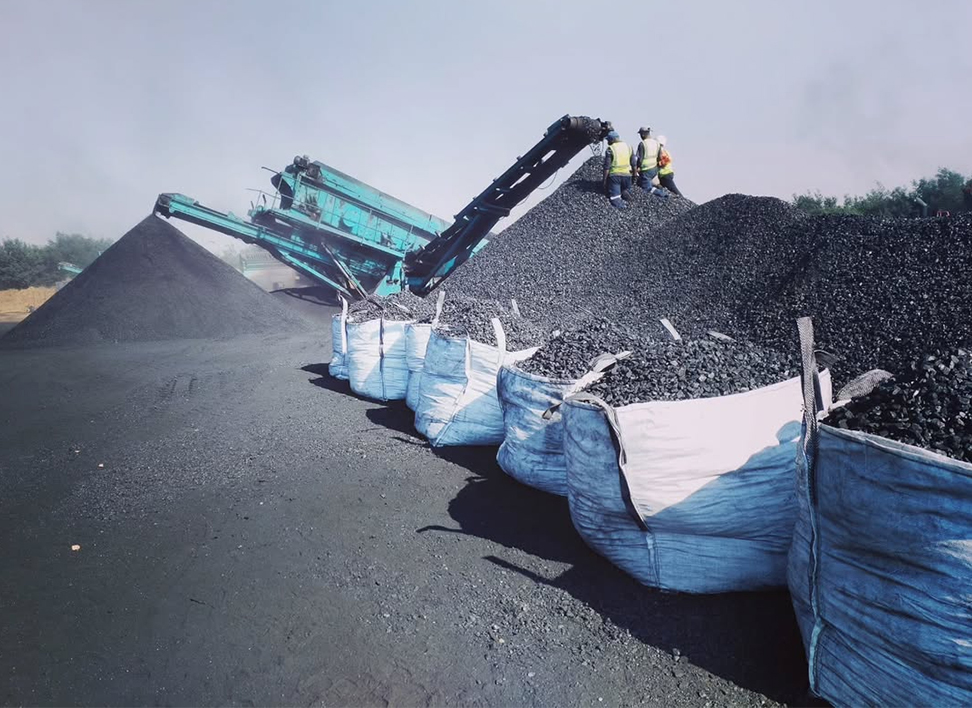 Bags of coal peas placed in front a head of coal at a wash plant.