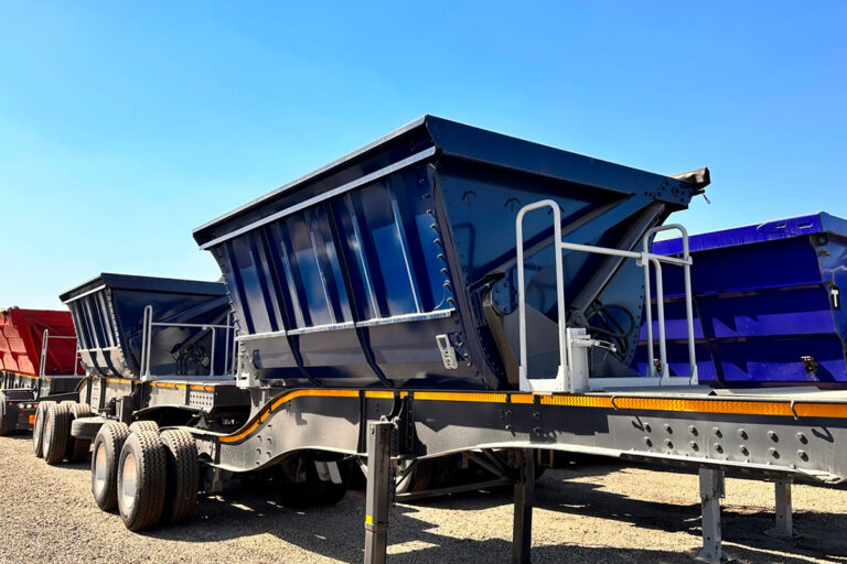 34 ton side tipper trailers parked in a gravel yard