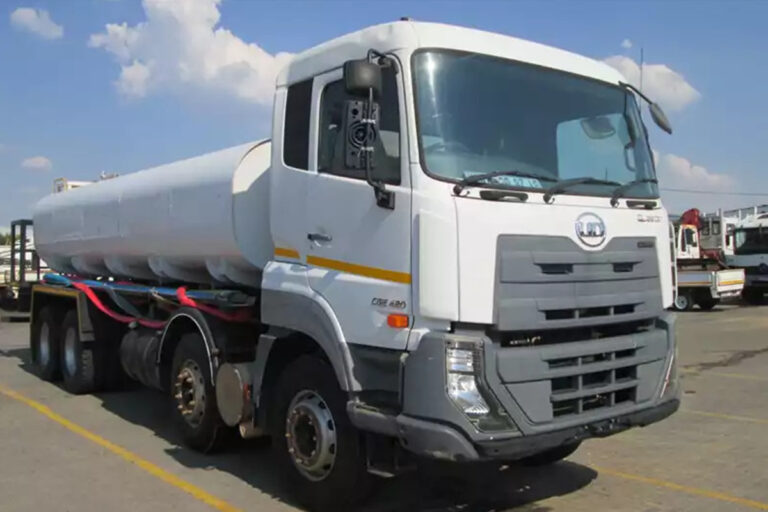 White 18000L water truck parked in a truck yard